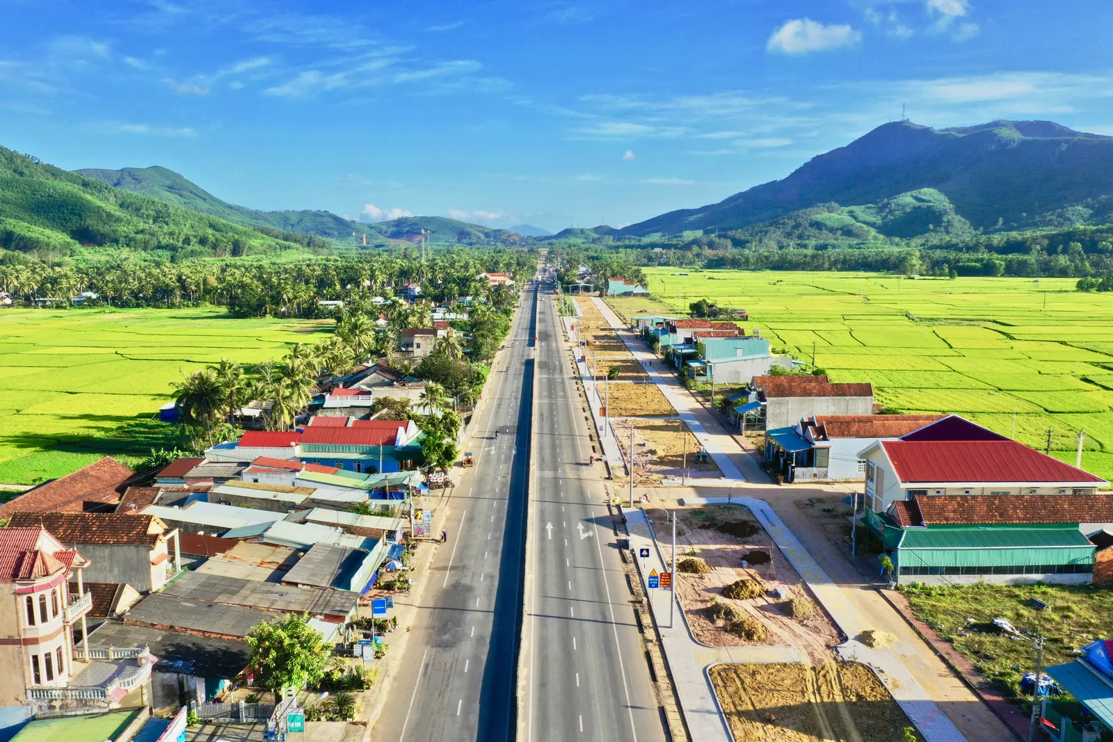 Aerial drone photo of a road through rice fields in Vietnam